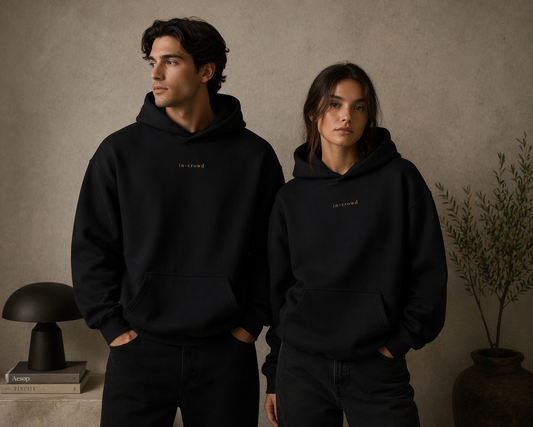 Two people wearing black hoodies with 'island' branding against a neutral background.